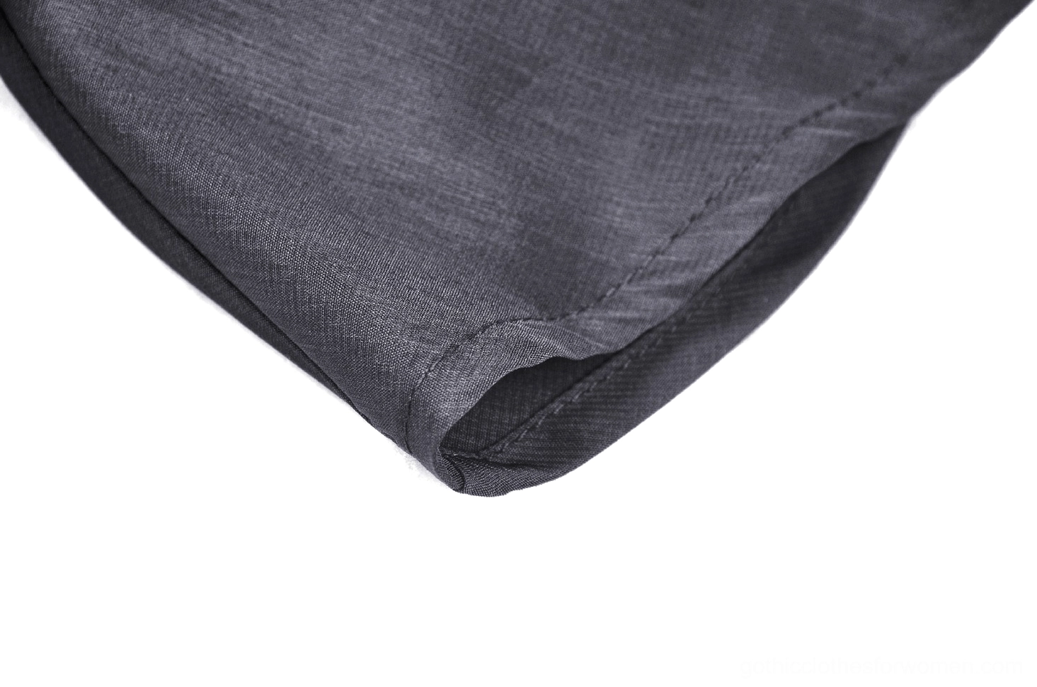 Fabric detail showing matte woven polyester lining and construction of black lace dress