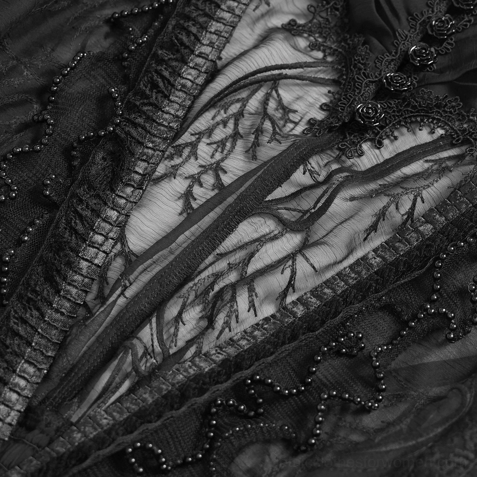Macro shot of black gothic dress sheer mesh and branch lace fabric composition showing intricate beading and overlay