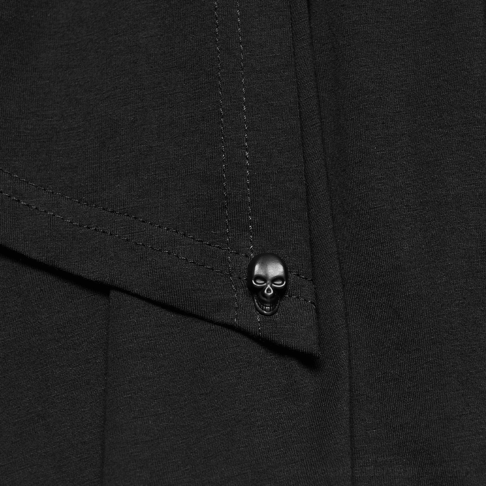 Close-up detail of skull-shaped metal trim and stitched woven lace fabric on gothic dress