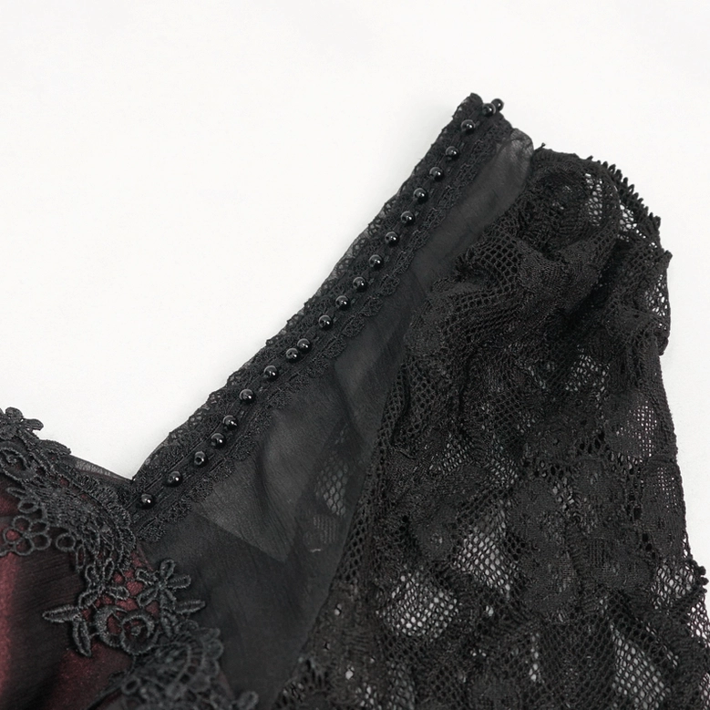 Close-up detail of gothic dress square neckline, black lace trim with beaded embellishment