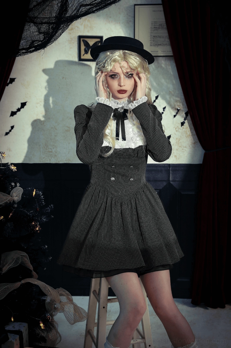 Black gothic pinstripe dress skirt detail showing flared silhouette and pleated construction