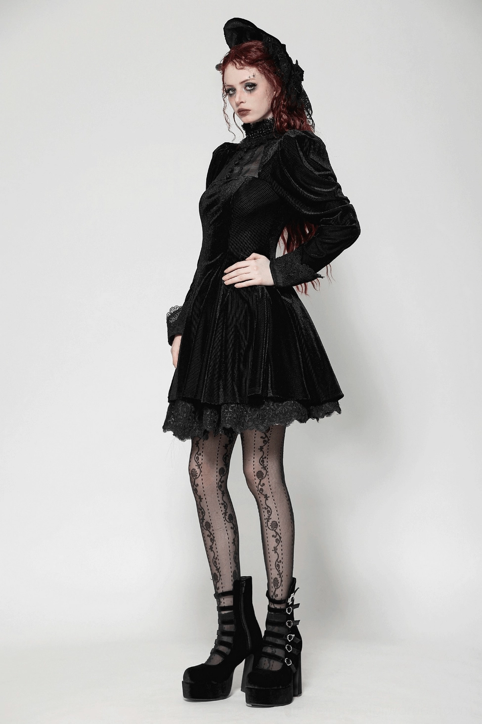 Styled view of black velvet gothic dress with puff sleeves and lace collar emphasizing the romantic goth aesthetic and mini length