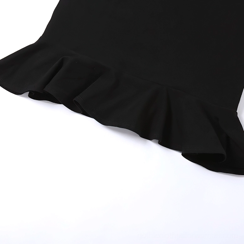 Close-up of black gothic mini dress ruffled hem, flat lay showing flared edge and smooth fabric texture
