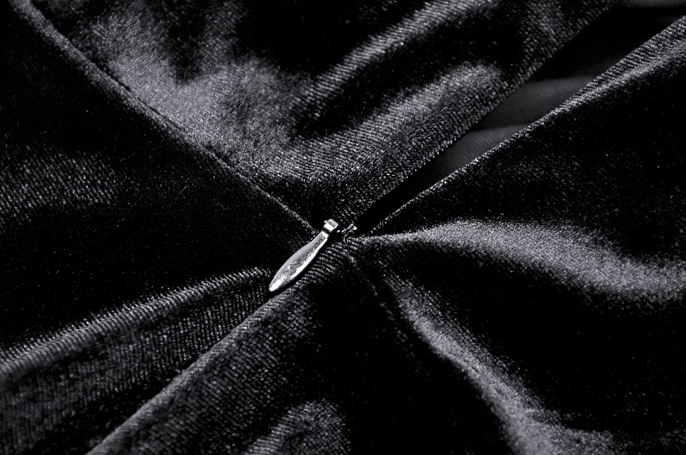 Detail shot of gothic dress ruffled lace hem and slit design, emphasizing layered ruffled trim and movement