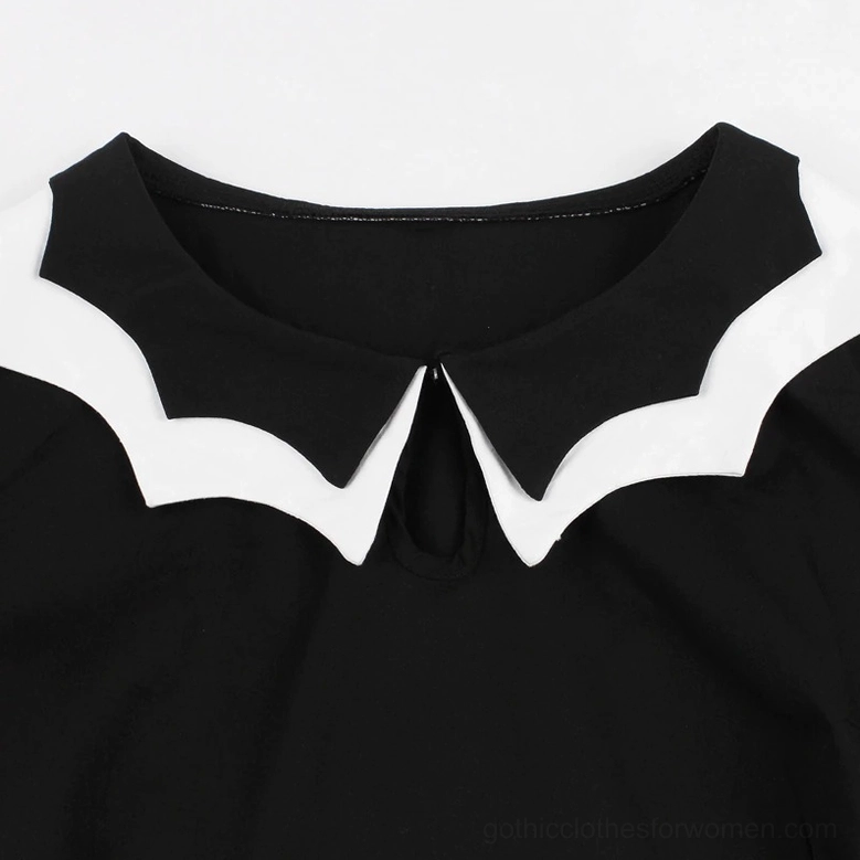 Close-up detail of black and white scalloped gothic collar neckline with keyhole cutout accent on bat embroidery dress
