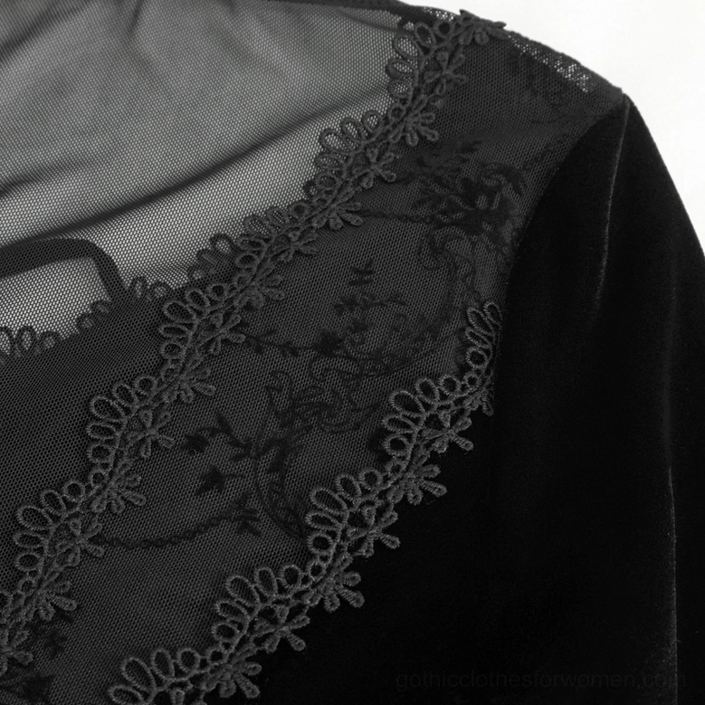 Close-up of Gothic dress shoulder and trim showing floral embroidered lace and sheer mesh construction