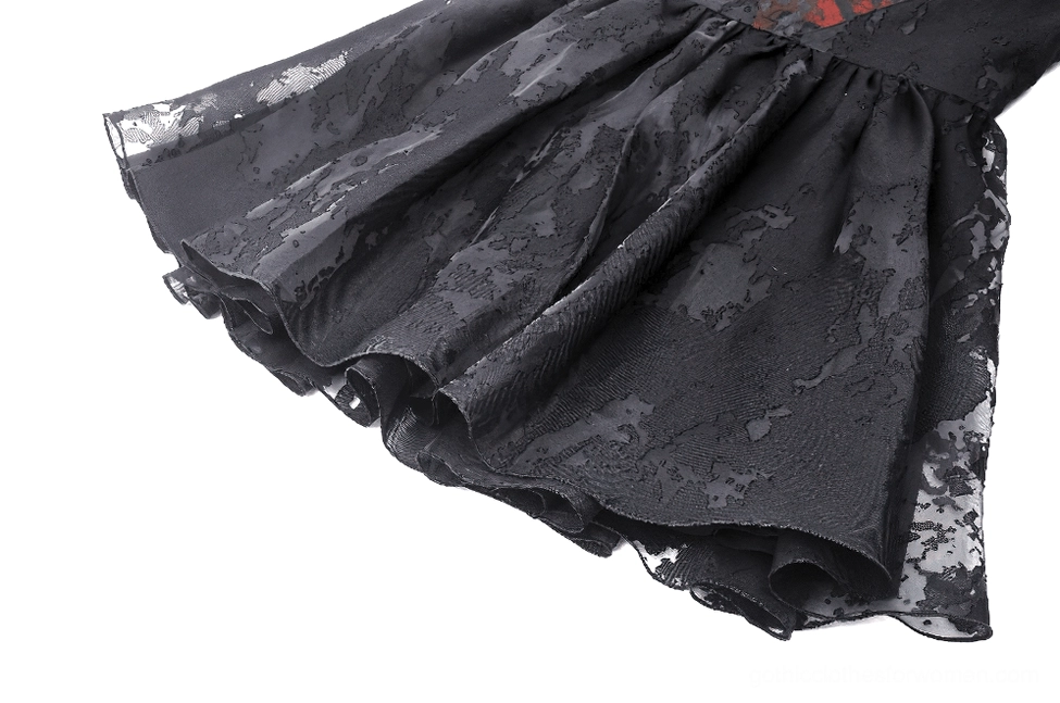 Close-up view of black gothic dress skirt featuring sheer jacquard tulle fabric with ruffled hemline detail