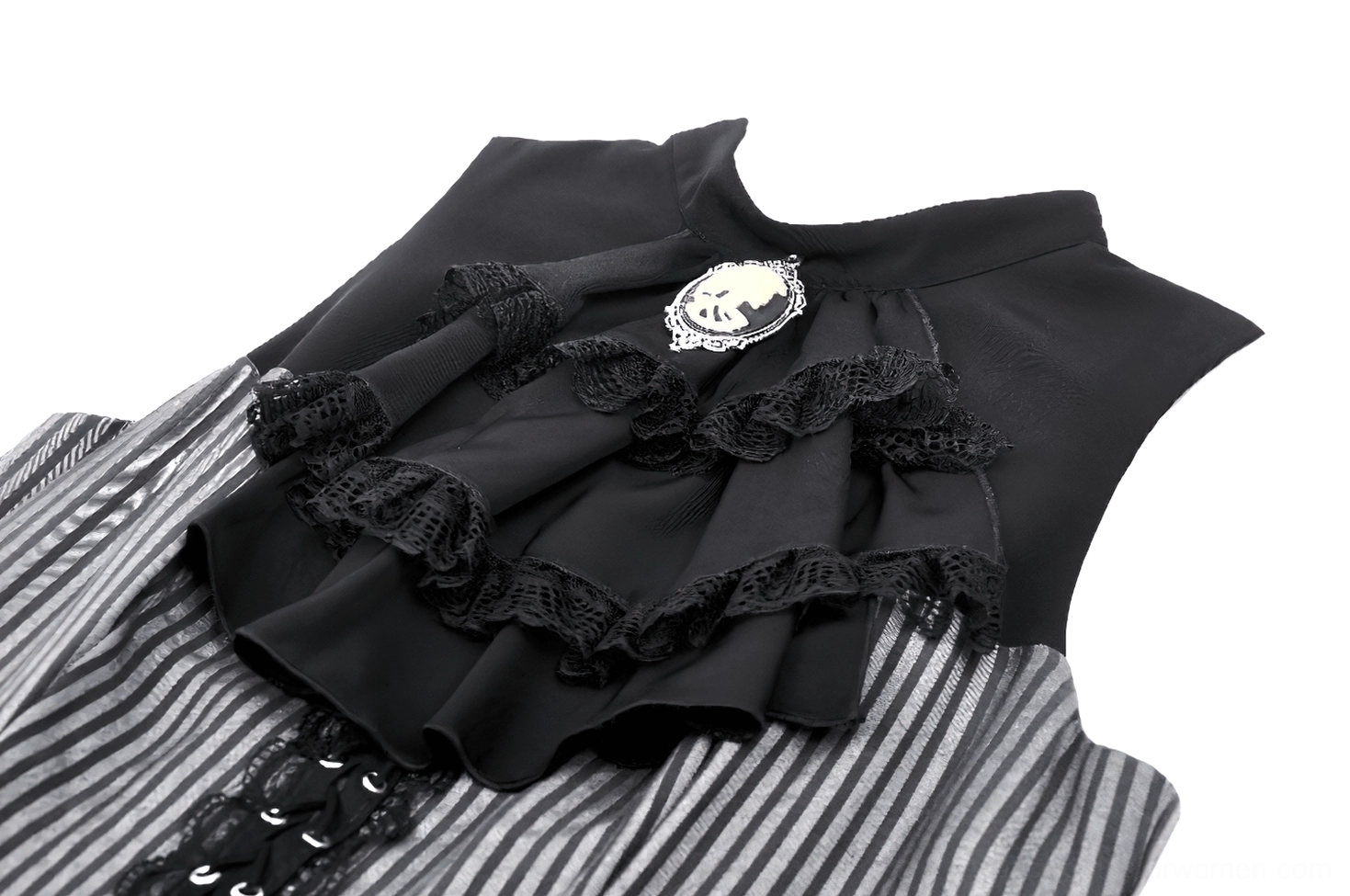 Close-up of black ruffled lace jabot with ornate skull cameo brooch and sleeveless armhole detail on gothic dress