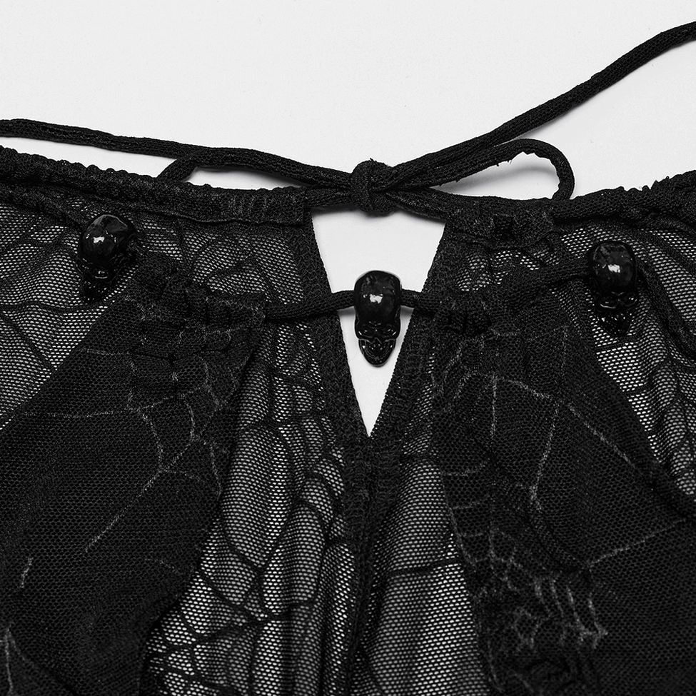 Close-up detail of gothic mesh dress showing skull accents, lace-up ties and spiderweb mesh fabric texture