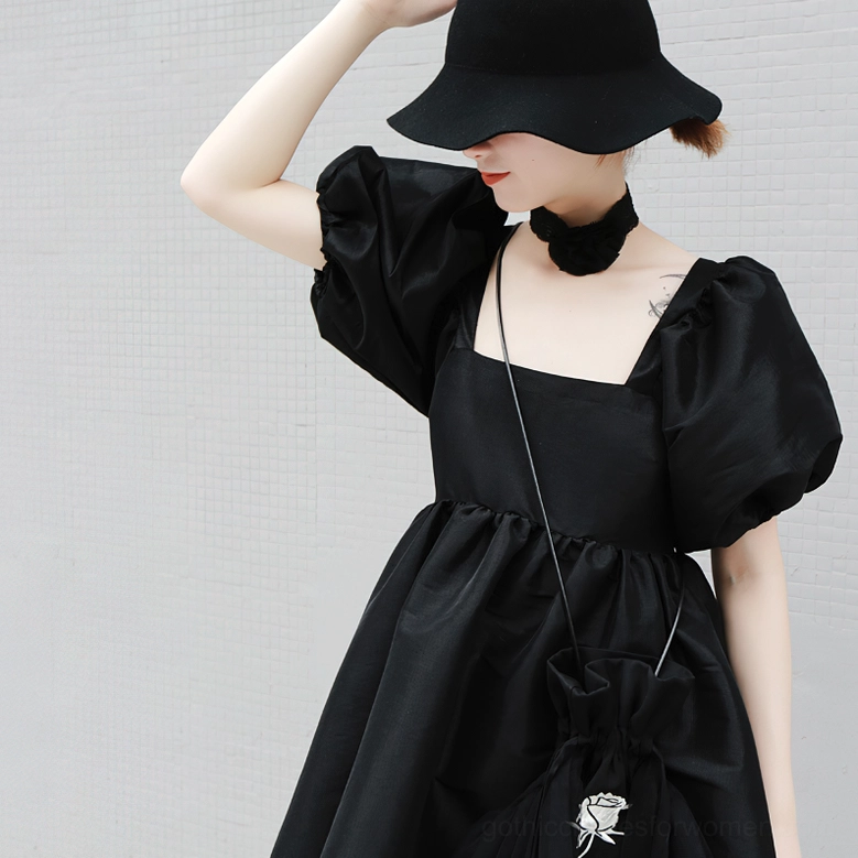 Close-up front view of black gothic mini dress showing square neckline and puff sleeve detail
