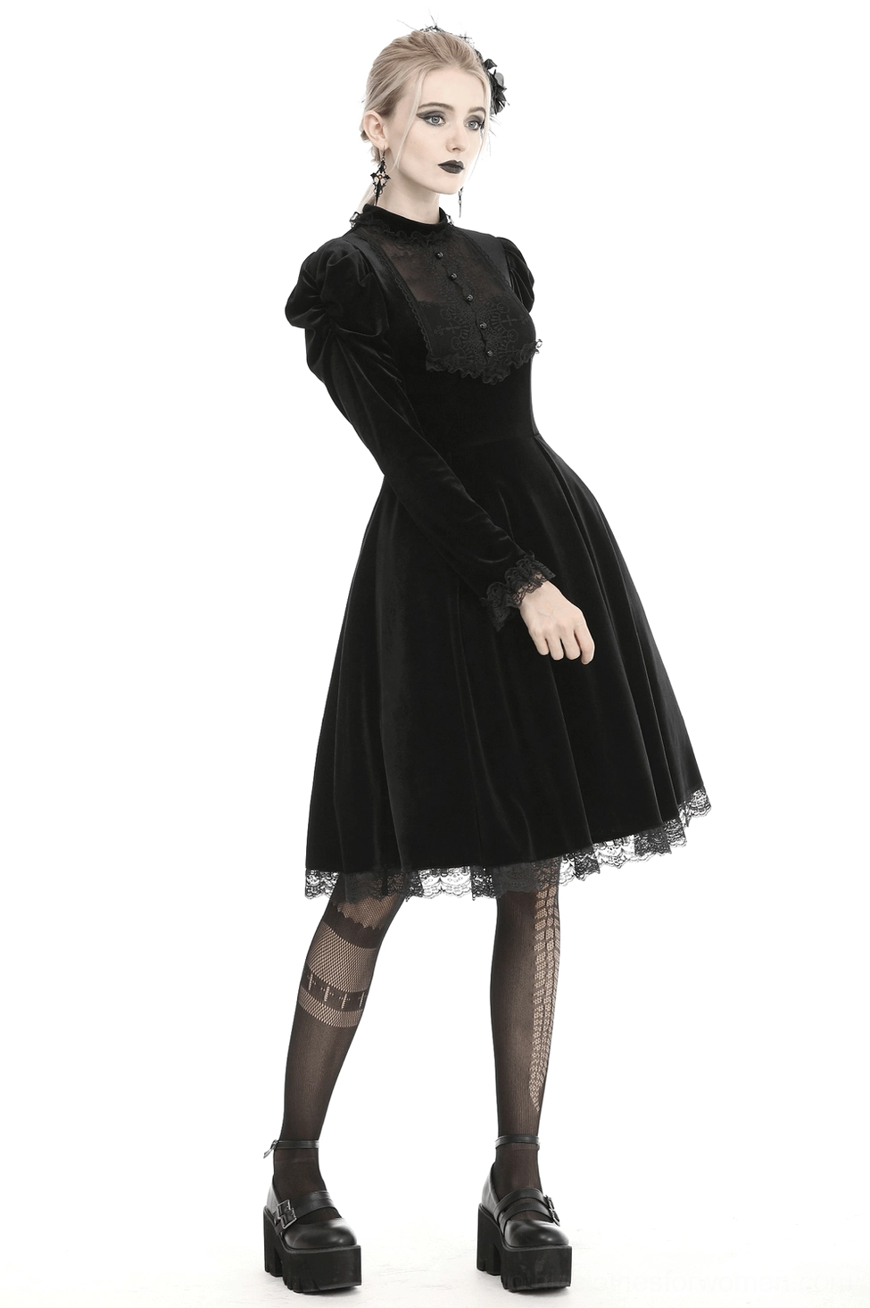 Model wearing black gothic velvet dress styled with dark accessories and dramatic makeup