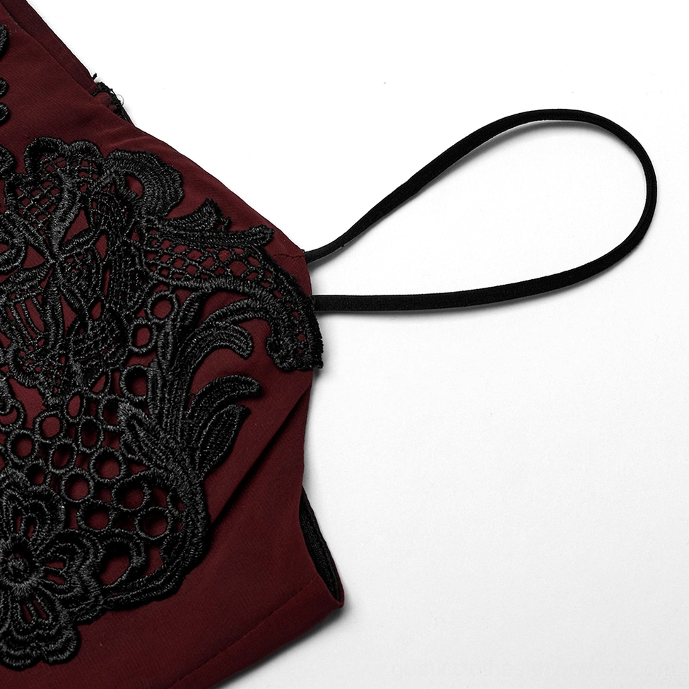 Close-up detail of thin black velvet spaghetti strap with floral lace applique