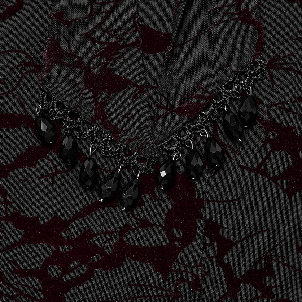 Close-up detail of water-drop pendant waistband jewelry with black metal chain trim for gothic maxi dress
