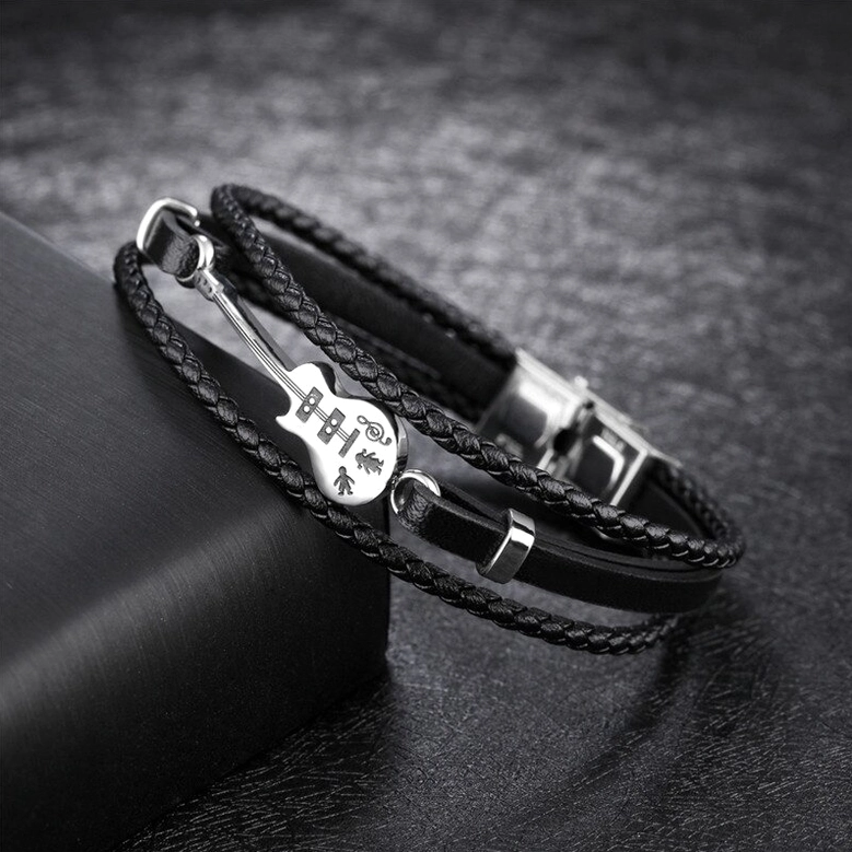 Dual braided gothic leather bracelet with polished stainless steel hardware and guitar charm, angled view
