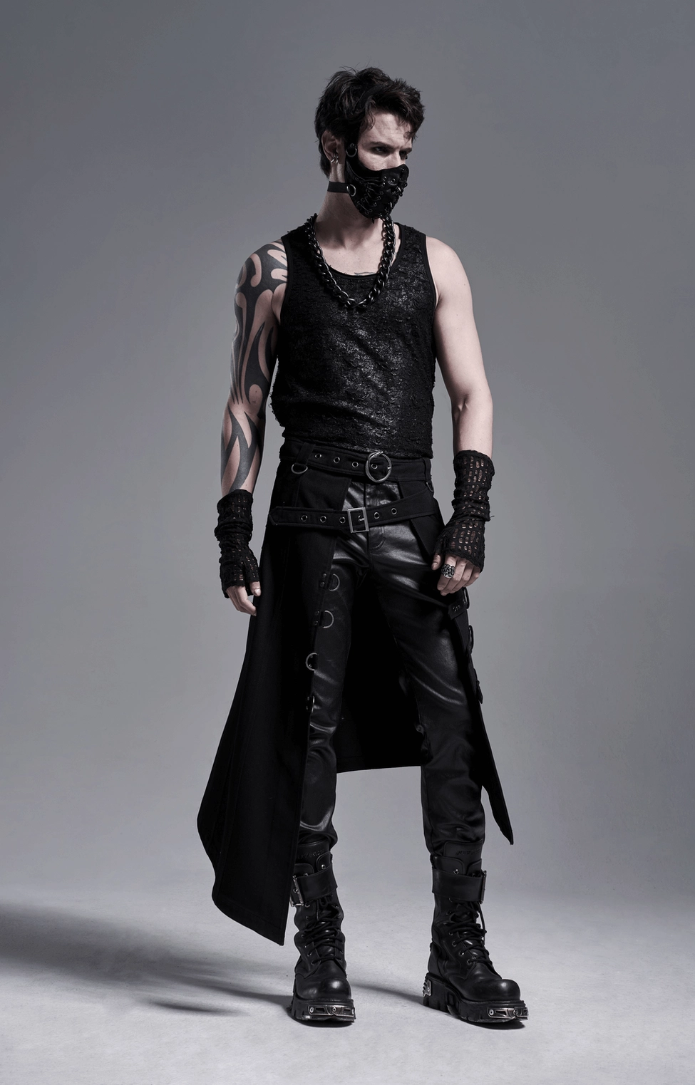 Side view gothic ensemble with black duster vest, leather pants, and matching distressed mesh fingerless gloves