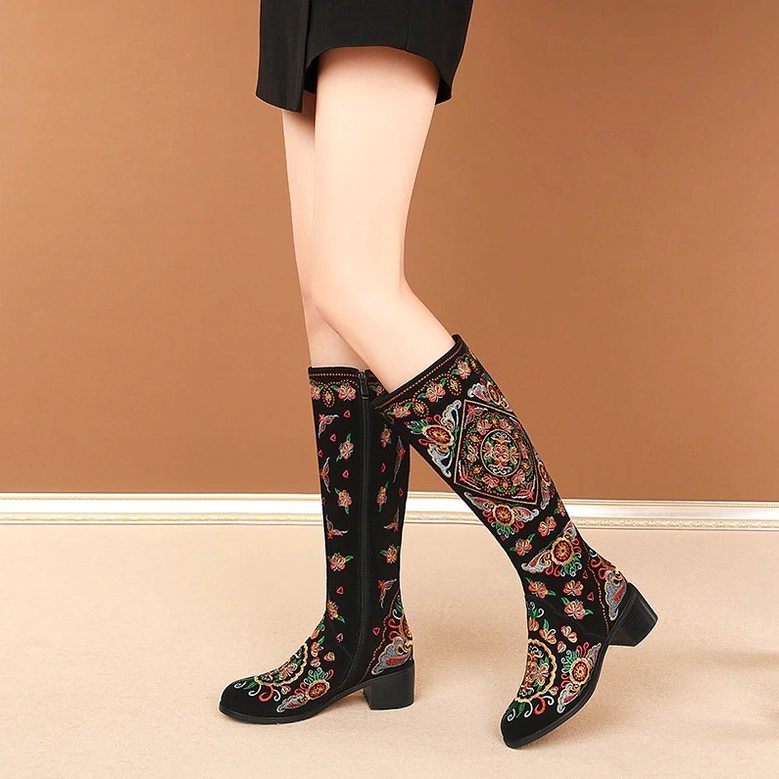 Pair of gothic embroidered knee-high boots featuring full colorful ethnic embroidery pattern, romantic goth aesthetic footwear