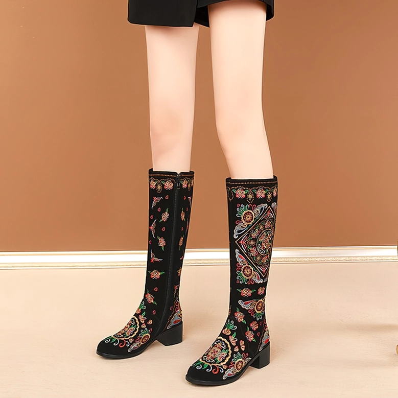 Black gothic embroidered knee-high boots showcasing hand-stitched colorful ethnic patterns, alternative fashion footwear detail