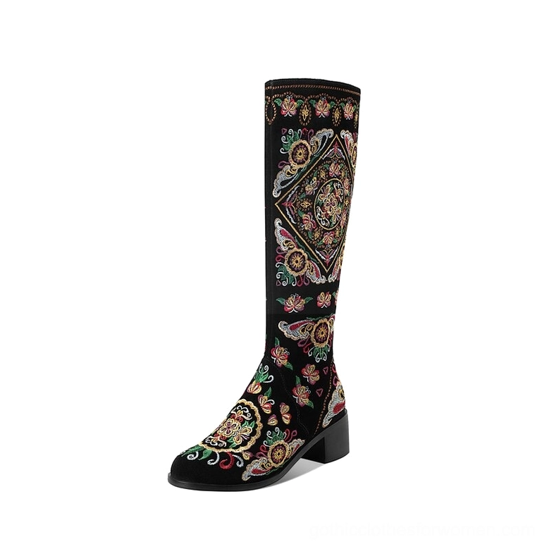 Black gothic embroidered knee-high boots with thick block heels, side profile view showcasing intricate colorful ethnic embroidery on genuine suede