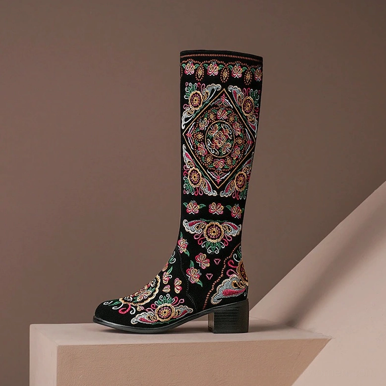 Single black gothic embroidered knee-high boot with ethnic floral embroidery and chunky block heels, three-quarter studio view