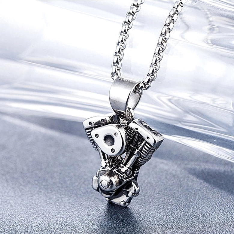 Side oblique view of vintage motorcycle engine pendant showing depth and three-dimensional gothic industrial craftsmanship