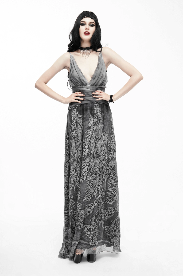 Gothic evening dress back view highlighting dramatic backless cut and leaf print skirt flow