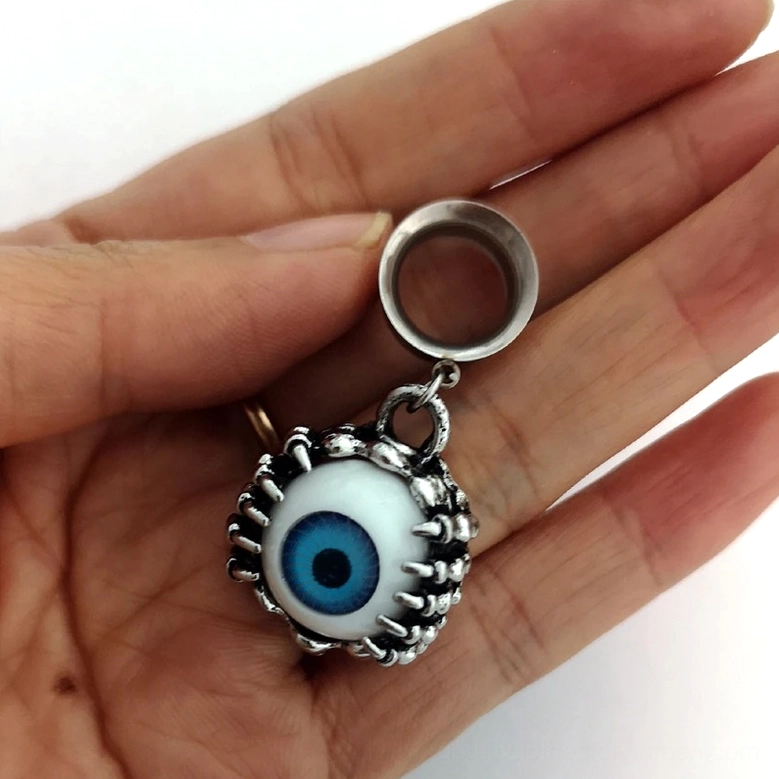 Gothic eyeball ear tunnel held in hand showing scale and dimensional depth, overhead close-up view