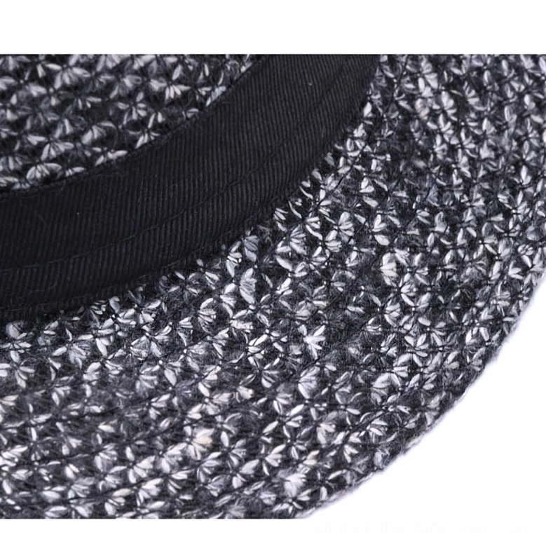 Close-up detail of black ribbon hat band and textured wool weave fabric of gothic fedora