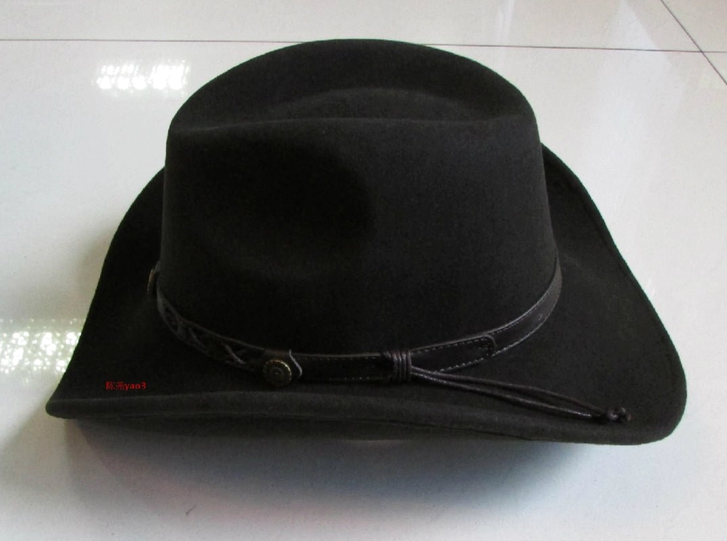 Side profile view of gothic fedora hat displaying leather strap with round metal fasteners and structured crown for alternative fashion