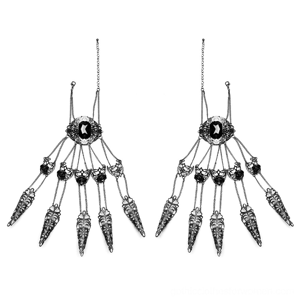 Flat lay of pair gothic finger hand chains showing complete design with black metal, central gemstone, ornate filigree work, and four claw nail pendants