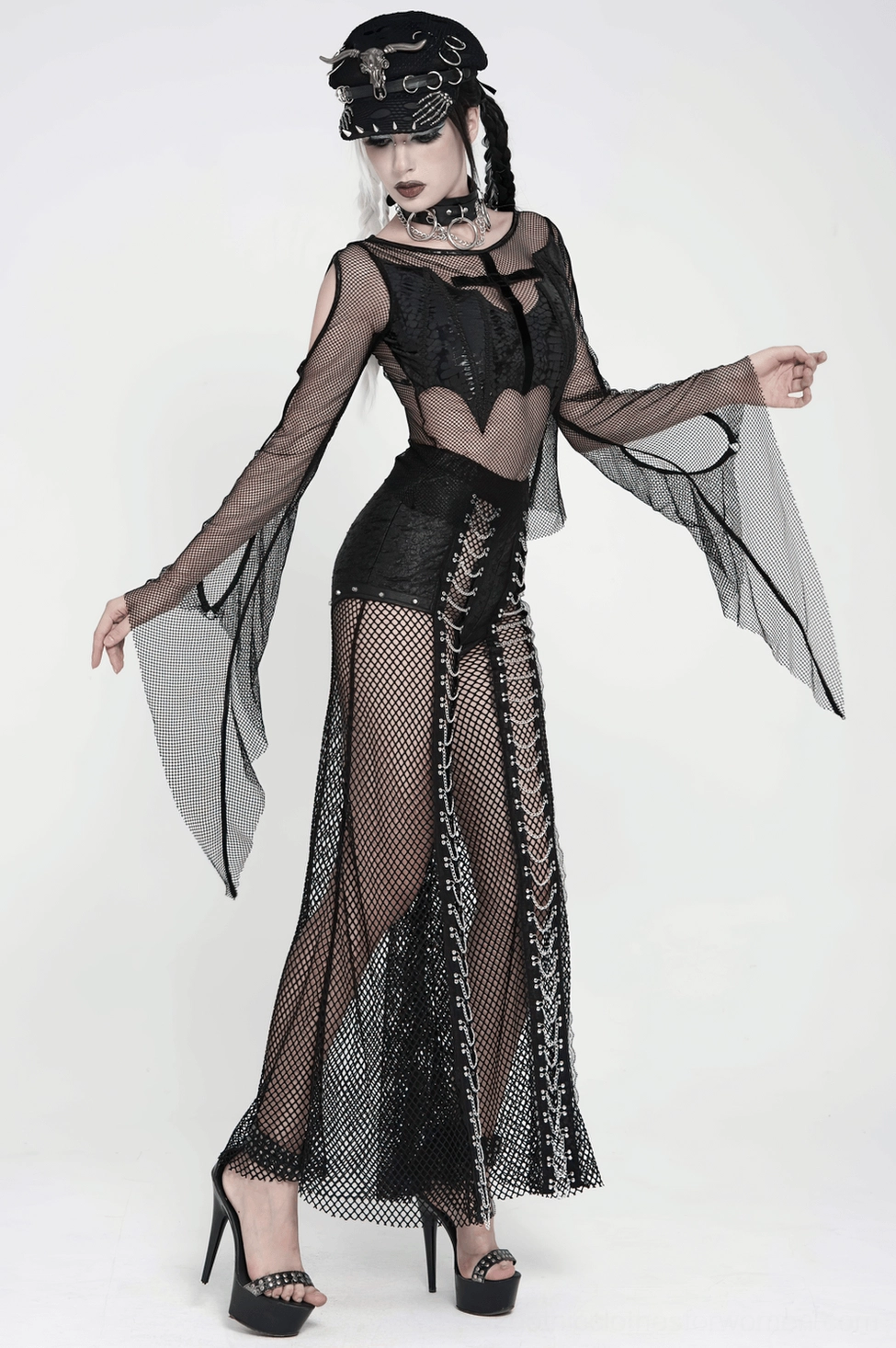 Alternative wear styling of black fishnet gothic pants with band tee and minimal accessories