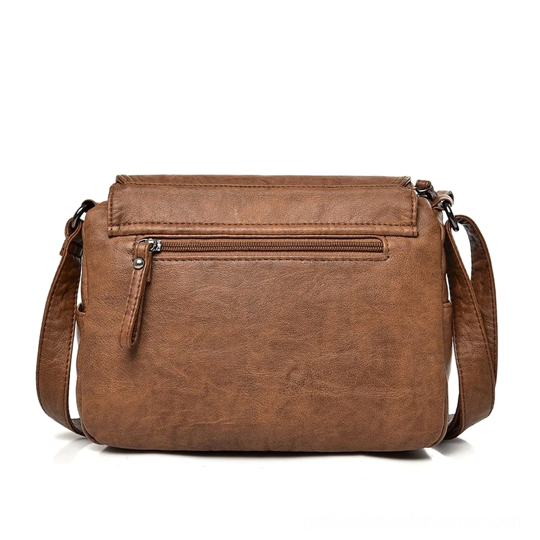 Gothic flap handbag detail view, soft leather twist-lock mechanism and structured design