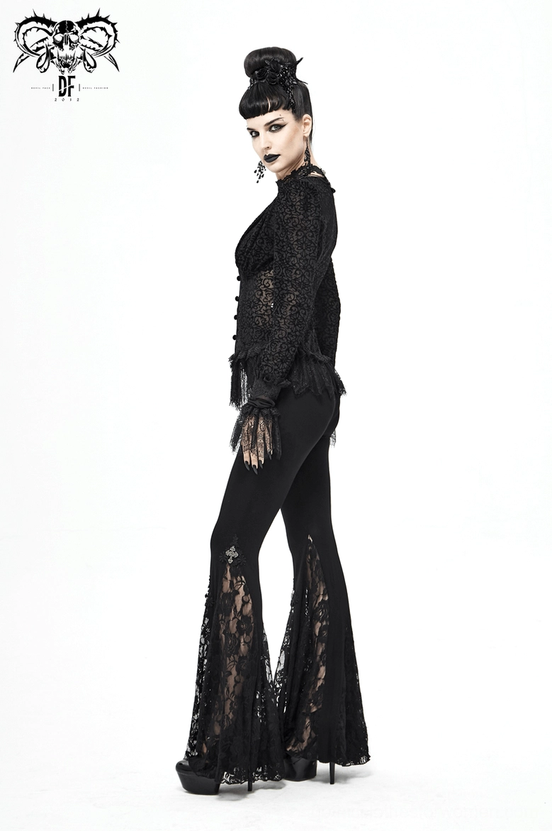 Detail shot of lace bell-bottom hem with metal cross ornaments on black gothic flare leggings worn by model