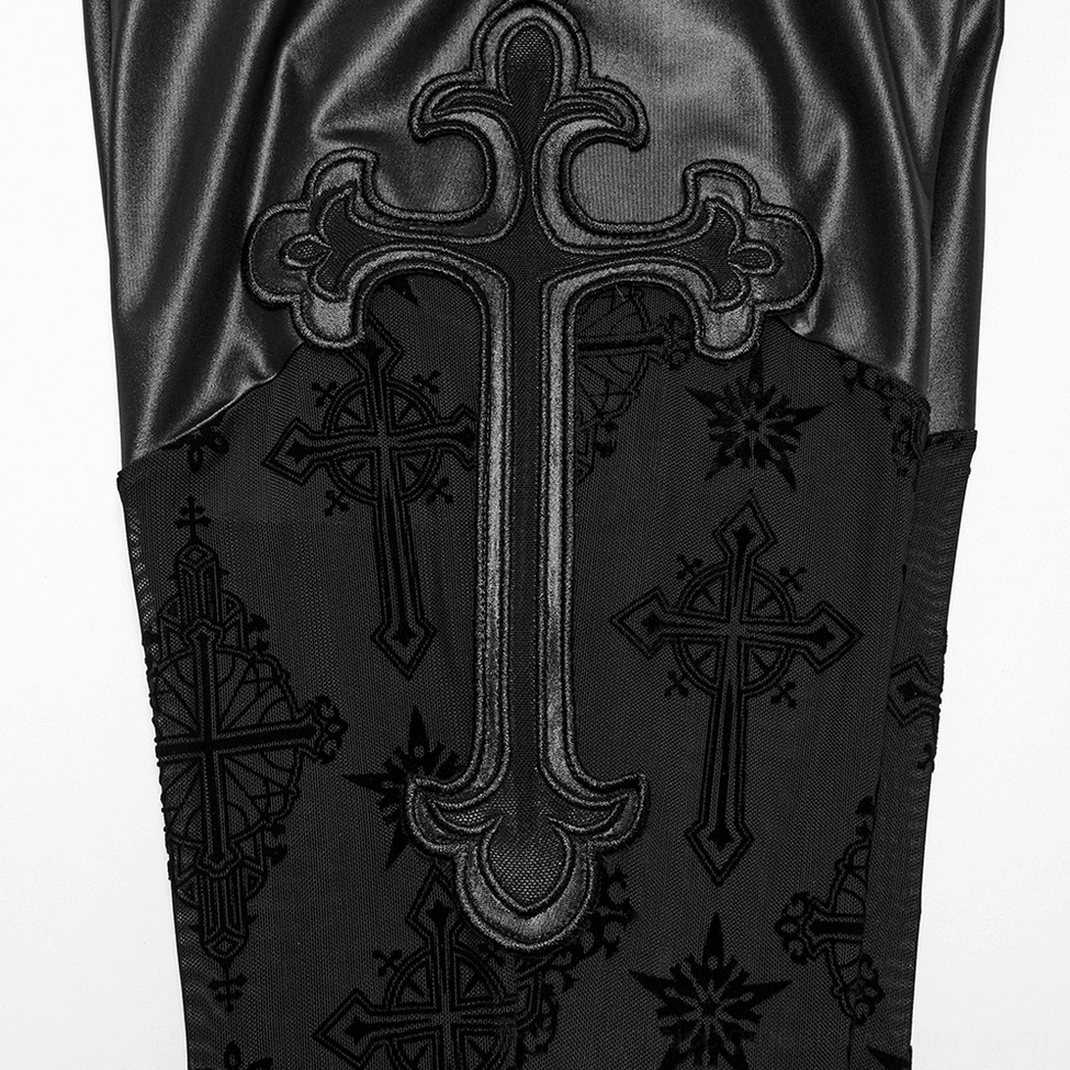Close-up fabric detail of gothic mesh flare pants showing large faux leather cross embroidery and delicate cross mesh prints