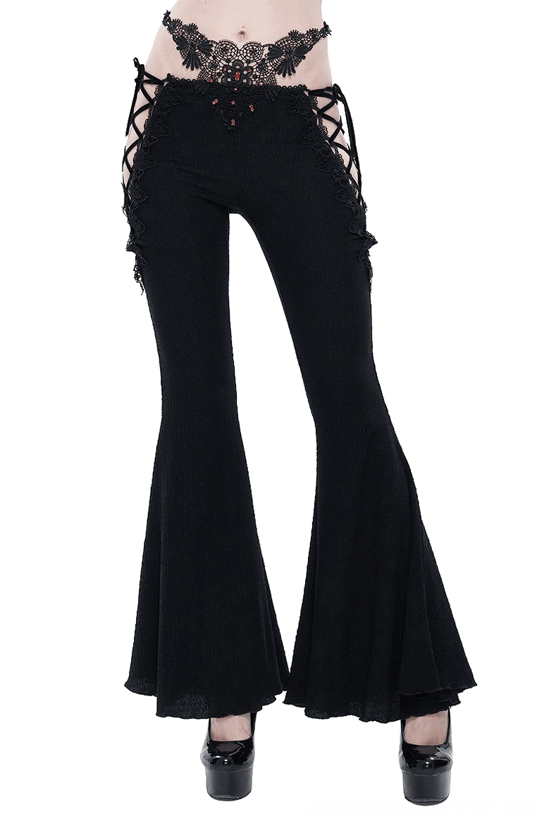 Gothic flared black trousers front view with red gemstone embellishments and lace cutout details