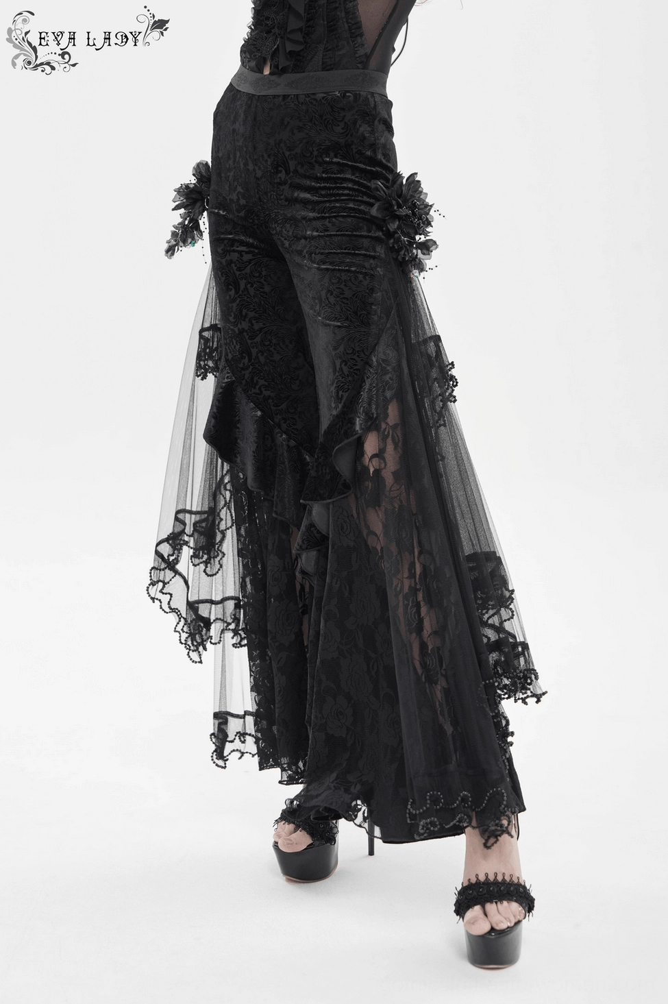 Black gothic flocked pants on model wearing alternative fashion styling with dark accessories