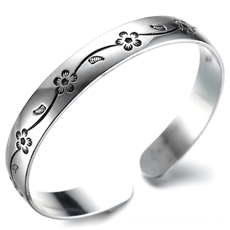 Silver plated open cuff bangle bracelet with gothic engraved floral vine pattern, 3/4 oblique view showing intricate flower details