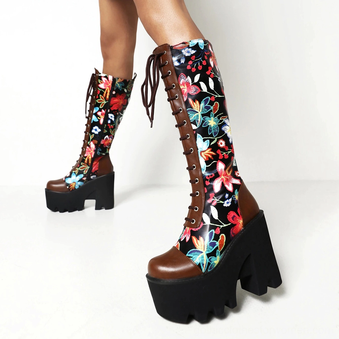 Close-up detail of gothic floral platform boot's botanical print pattern, lace-up system, and chunky TPU sole