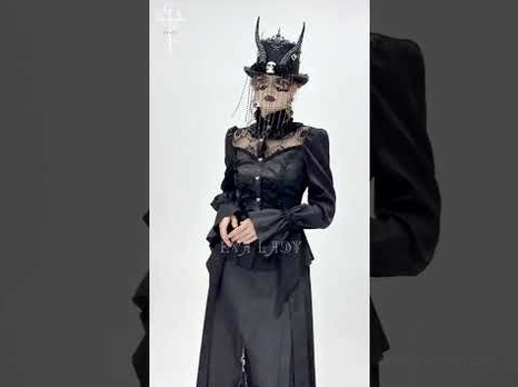 Black gothic formal blouse on model with horn headwear, fitted long sleeves, high structured collar, studio shoot