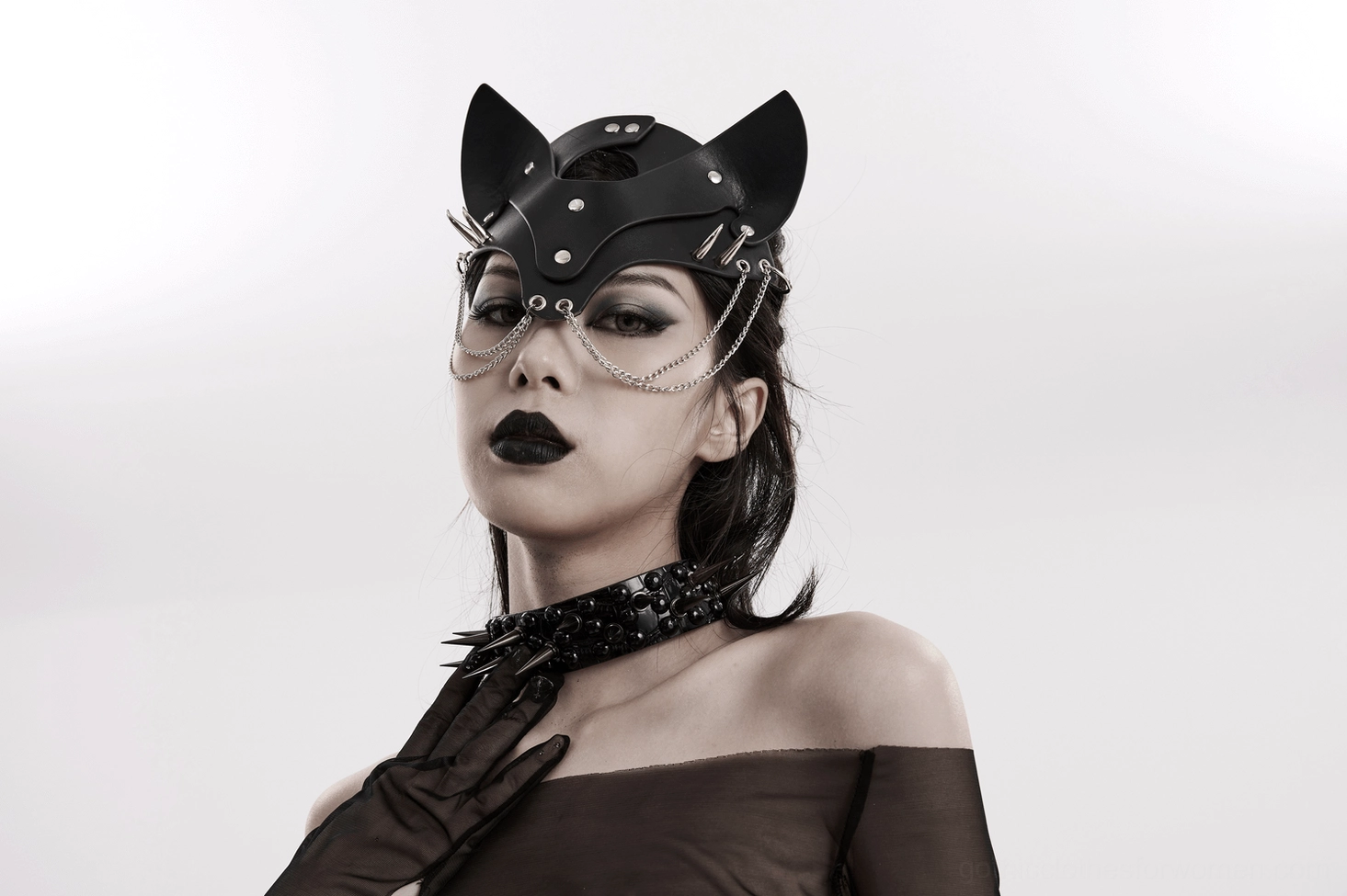 Black gothic fox mask with silver chains and studs worn by goth model with spiked choker and leather gloves, side front view