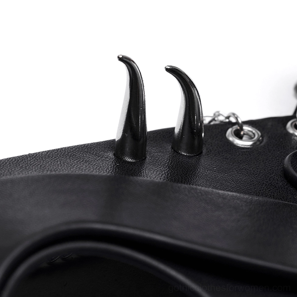 Macro close-up detail of black fox mask showing smooth faux leather texture, resin horns, and metal eyelet fasteners