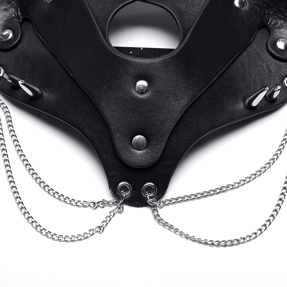 Top-down macro detail of black faux leather fox mask showcasing metal studs, spike accents, and silver chain decorations