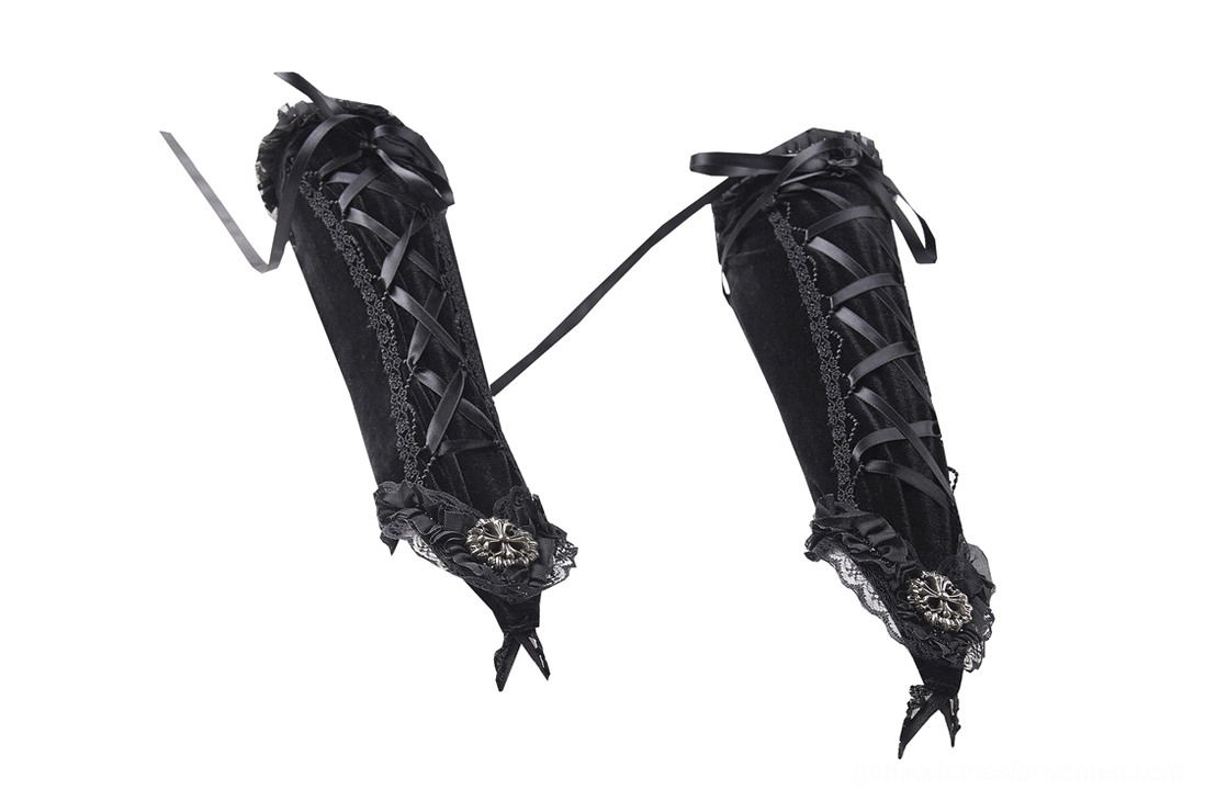 Side flat lay of black gothic fingerless gloves showing velvet texture, cross ribbon trim, and ornamental cuff decorations