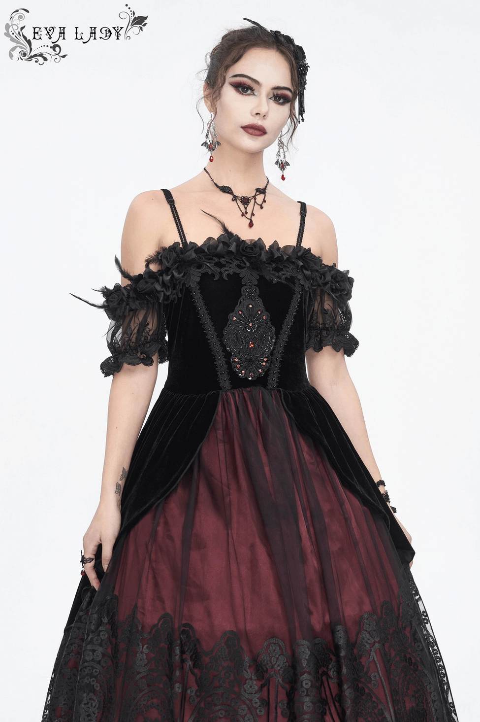 Gothic Victorian ball gown detail showing feather embellishments and luxurious velvet fabric texture up close