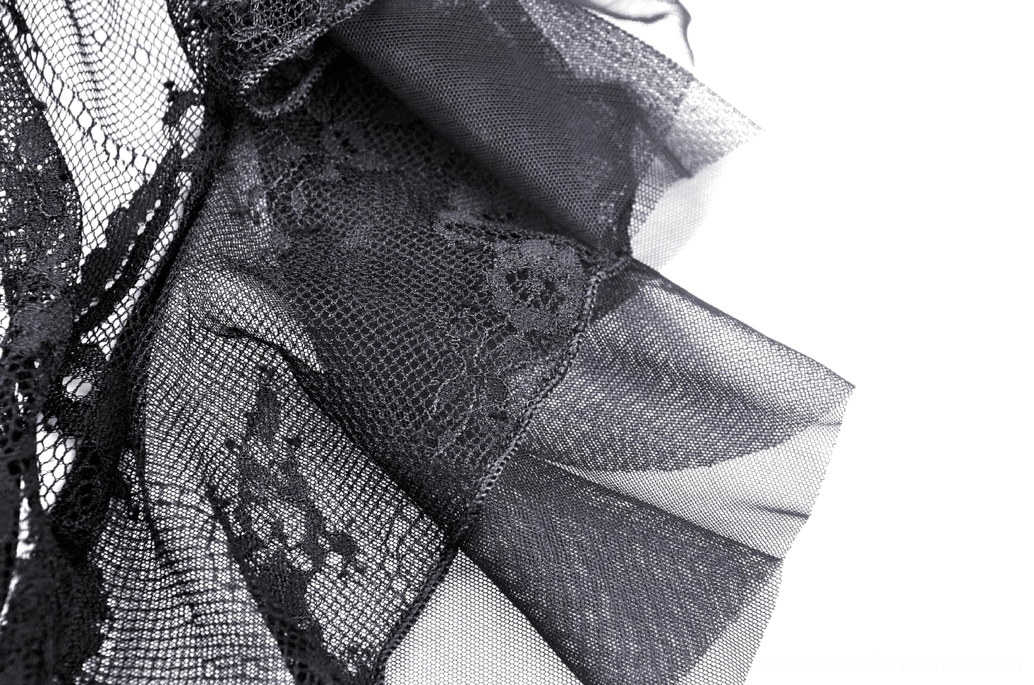 Close-up of layered sheer black mesh and lace draped fabric construction in gothic gown