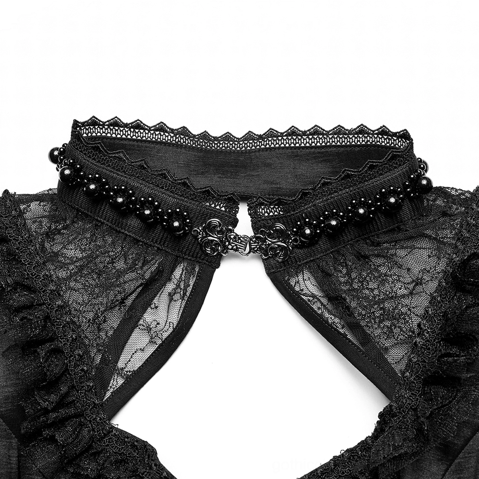 Close-up macro of gothic gown square neckline showing beaded lace collar trim and decorative metal clasp hardware