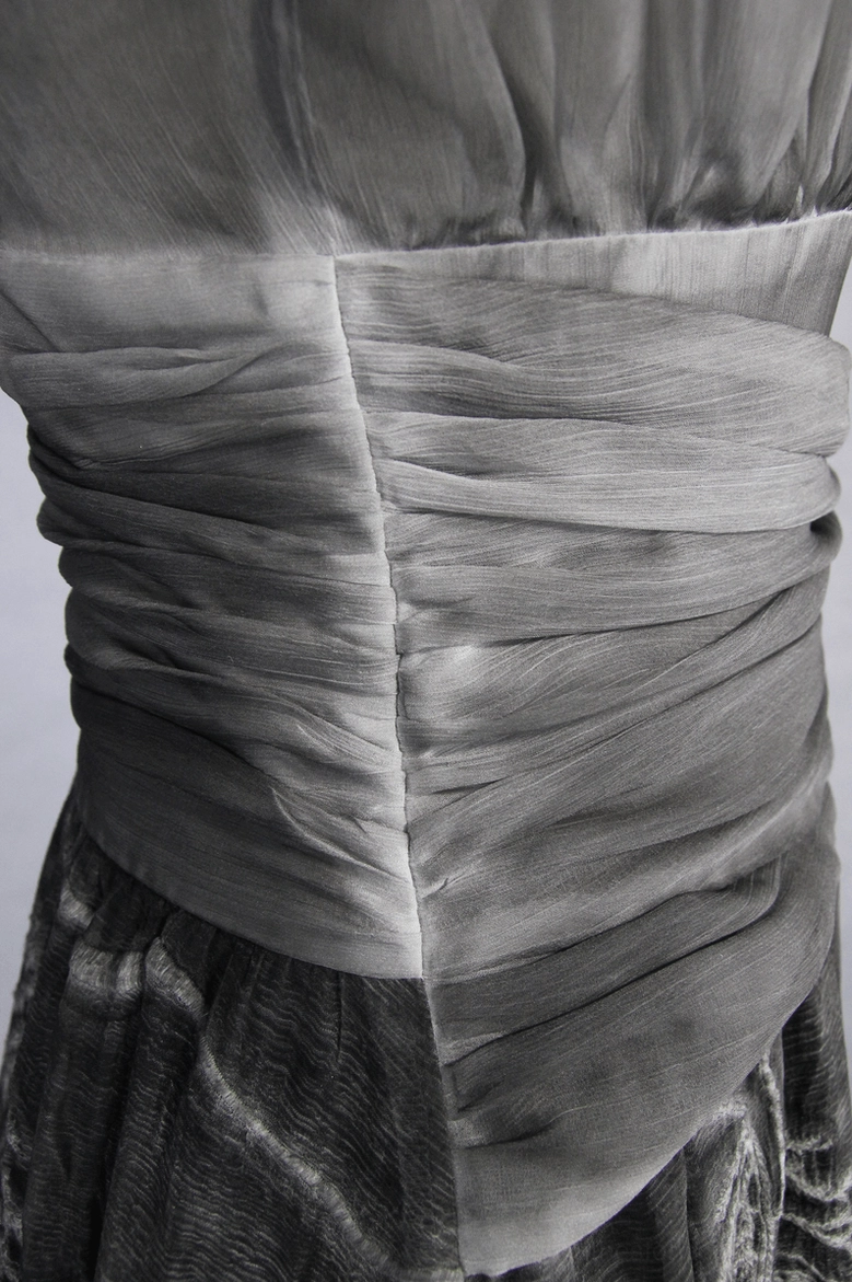 Gothic grey maxi dress detail shot showing vintage leaf print pattern and silk fabric texture