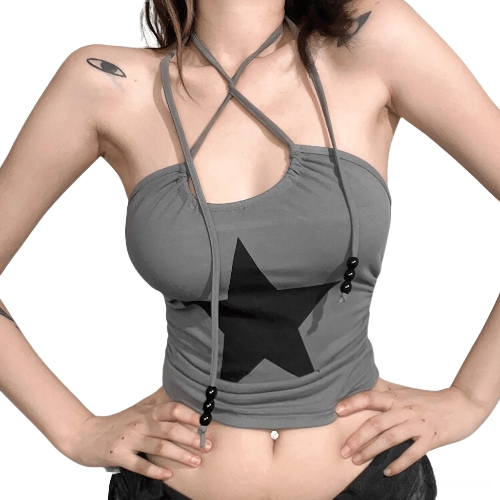 Front three-quarter view of slim cropped grey star cami with hands on hips, showing edgy alternative silhouette