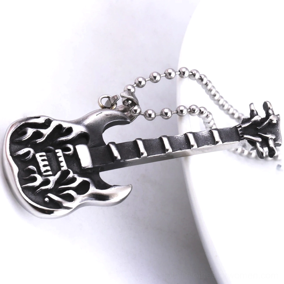 Side angle view of stainless steel guitar pendant necklace displaying flame-carved design detail on polished metal