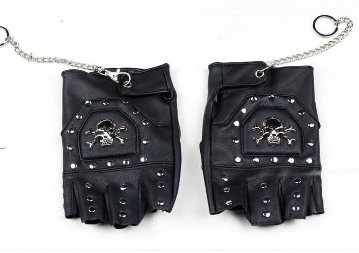 Black half-finger gothic gloves pair flat lay decorated with skull motif and metal rivets with chain detail