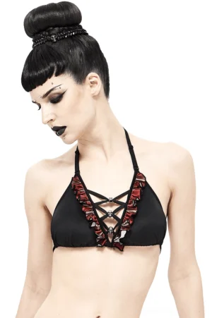 Black and red plaid gothic halter bikini top with skull pendants worn by model with gothic styling, front three-quarter view on white background